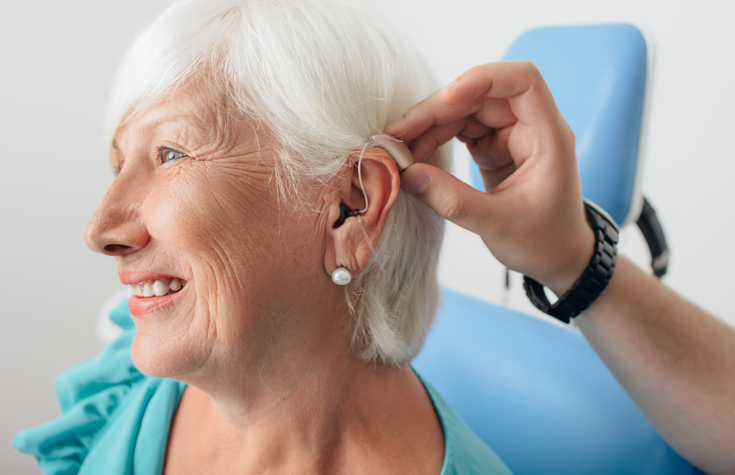 senior lady being fitted for hearing aids