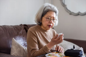 A senior woman works to improve diabetes management as she regularly checks her blood sugar.